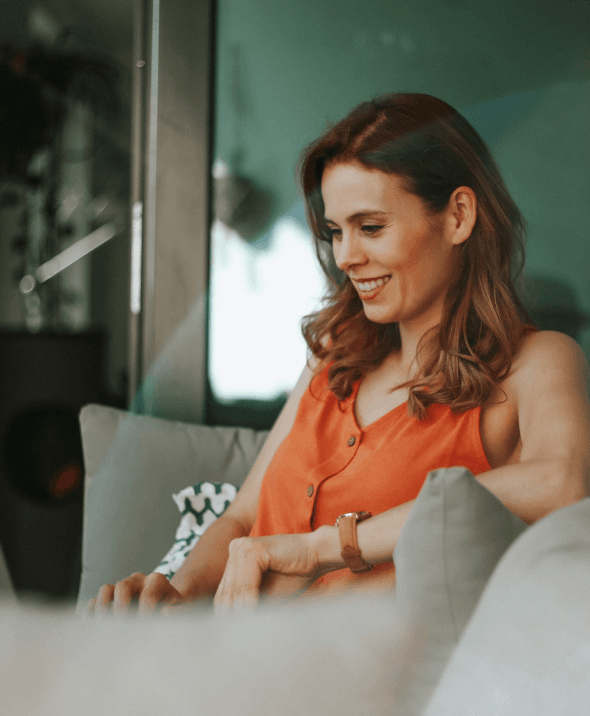 Woman smiling working on laptop